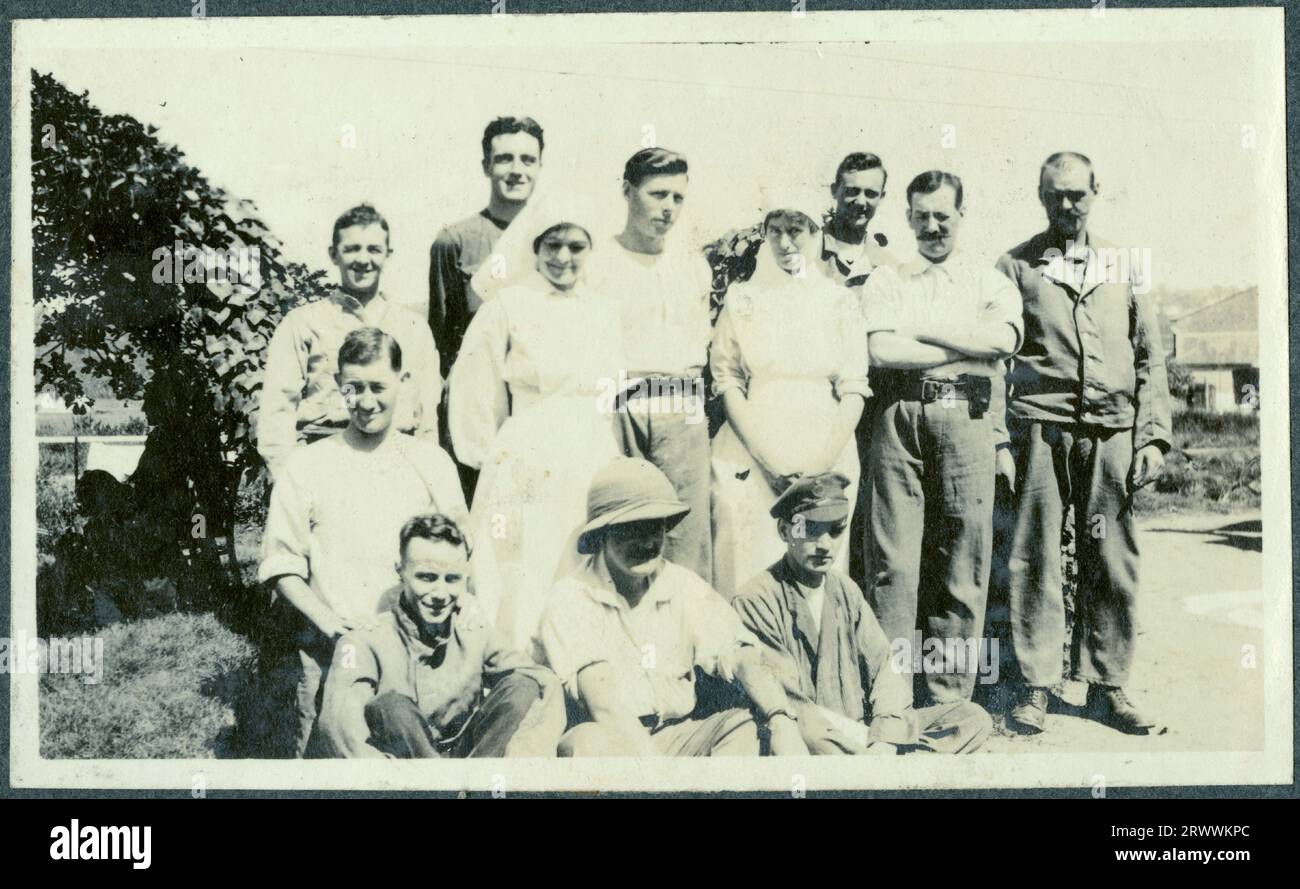 Foto di gruppo informale di dieci soldati della prima guerra mondiale con due infermiere raffigurate a Durban, presumibilmente nel terreno dell'ospedale. Didascalia originale del manoscritto: Un gruppo di pazienti a Durban. Foto Stock