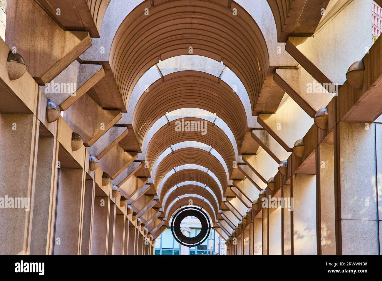 Symmetrical and optical illusion ceiling with curving openings with tunnel view to black opening Foto Stock