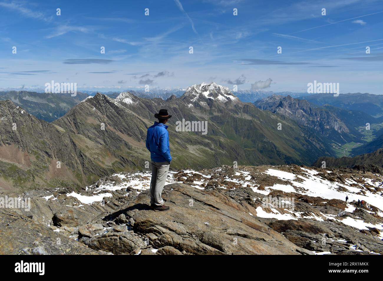 Alpinista che guarda la cima dell'Habicht nelle Alpi dello Stubai con neve fresca, vista dallo Schneespitze, alto Adige, Italia Foto Stock