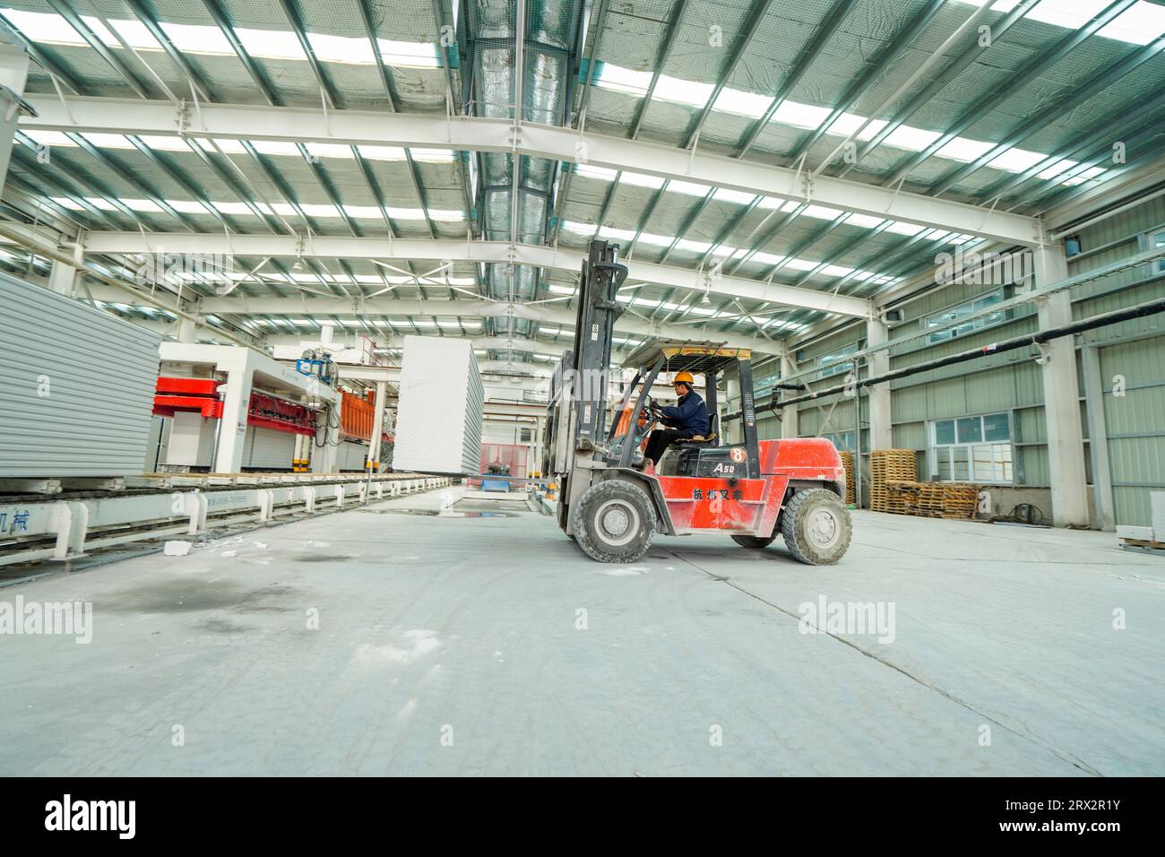 Contea di Luannan, Cina - 13 ottobre 2022: I lavoratori trasportano nuovi materiali edili con carrelli elevatori a forche - pannelli divisori leggeri, contea di Luannan, Hebe Foto Stock