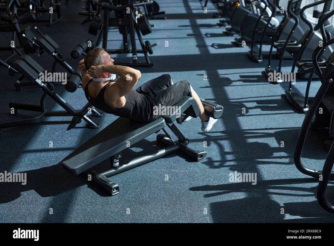 Uomo forte che fa esercizio addominale in palestra Foto Stock