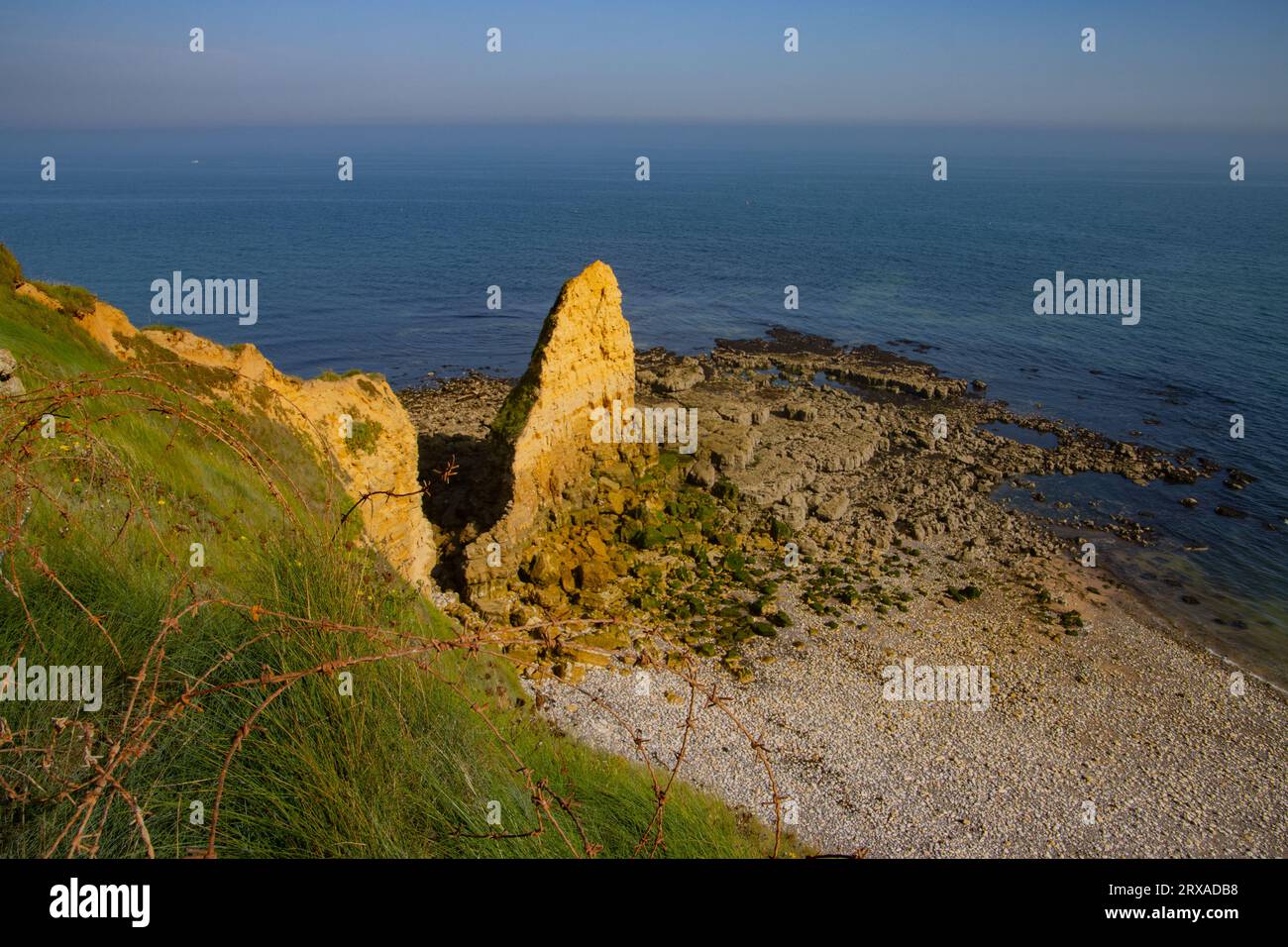 Vista della costa della Normandia con filo spinato in primo piano da Pointe du hoc Foto Stock
