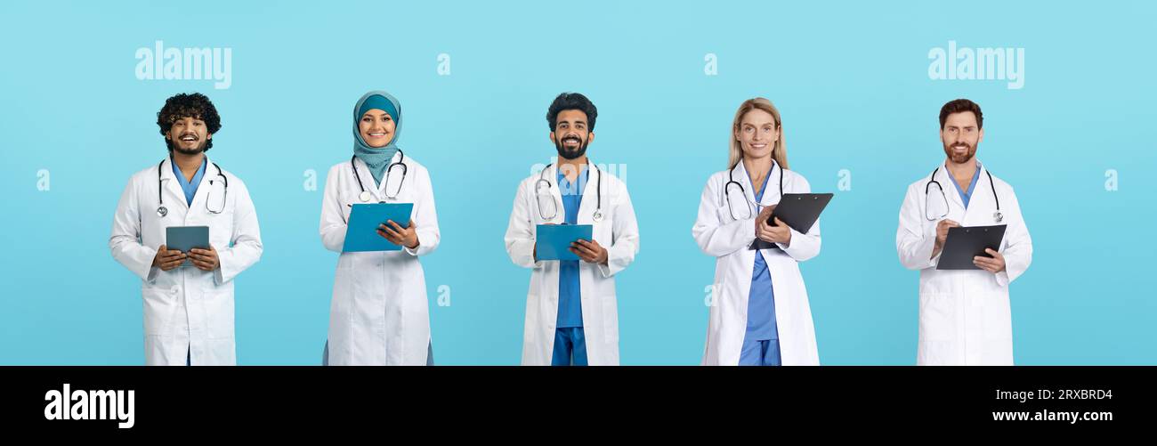Felici medici arabi ed europei adulti in camici bianchi con compresse e appunti Foto Stock