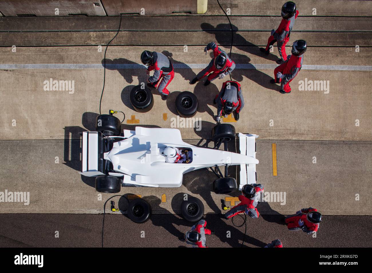 Pit crew in perfetta sintonia durante una gara ad alta velocità di un giorno di pit stop. Foto Stock