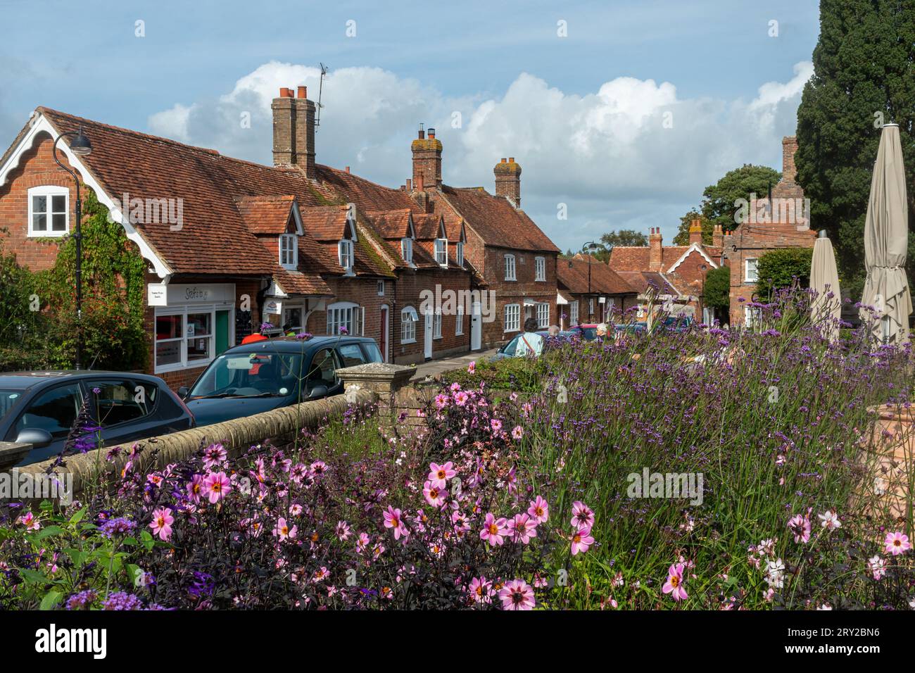 Vista di Beaulieu High Street dal Fairweathers Garden Centre con fiori in primo piano, New Forest, Hampshire, Inghilterra, Regno Unito Foto Stock