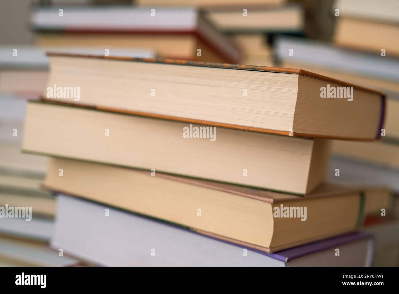 Una pila di libri con copertina rigida chiusa in biblioteca Foto Stock