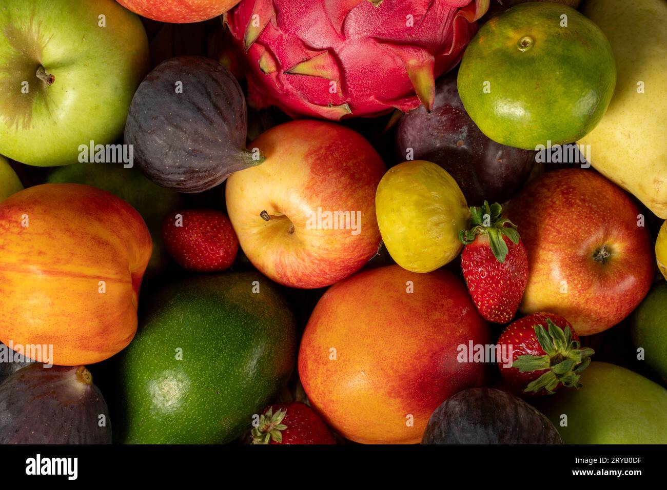 Primo piano su fondo di frutta fresca e colorata. Frutta mista. Primo piano. Uva, fichi, fragole, mela, pera, kiwi, pesca. Vista dall'alto Foto Stock