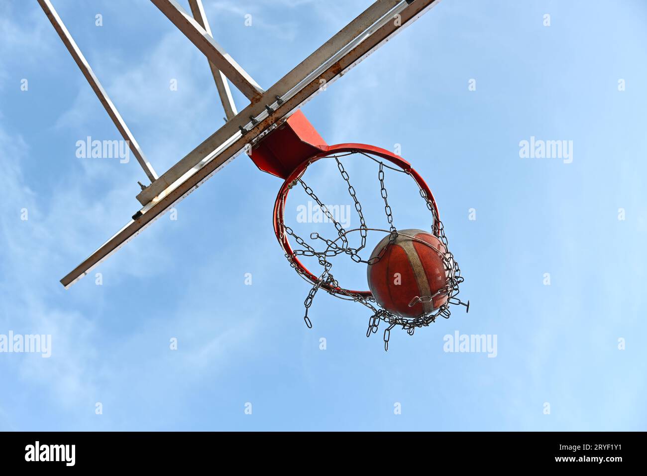 Tirare la palla da basket arancione nel cesto Foto Stock