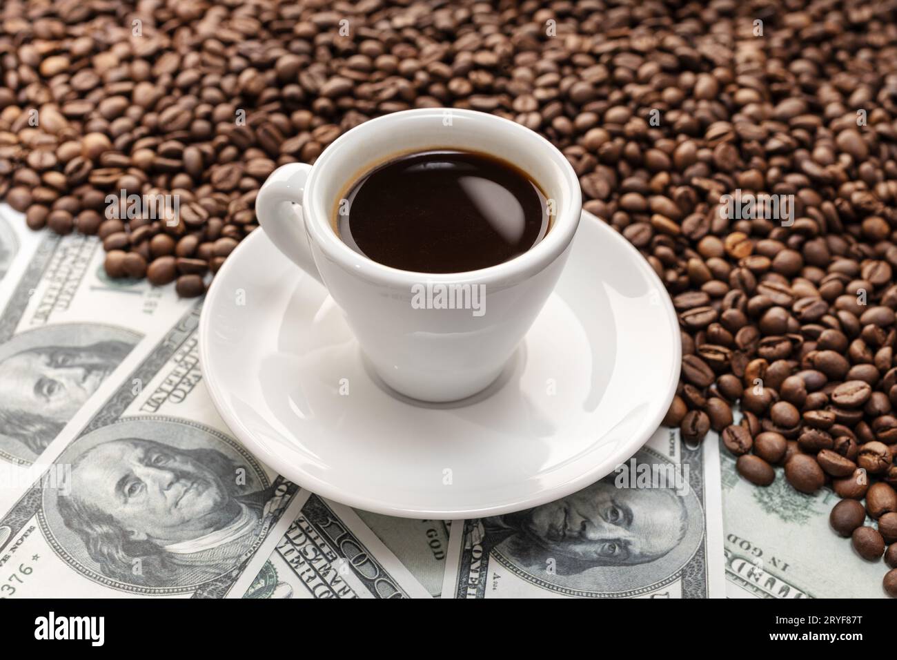 Tazza di caffè su chicchi di caffè e banconote in dollari di fondo Foto Stock