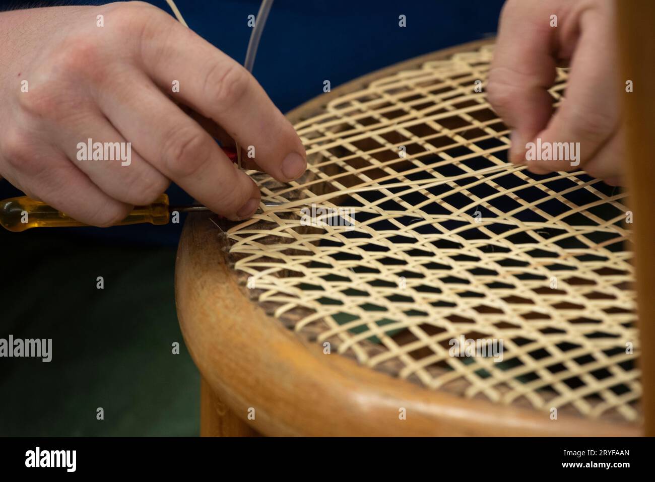 Tessitura del cestello in un'officina riparata Foto Stock