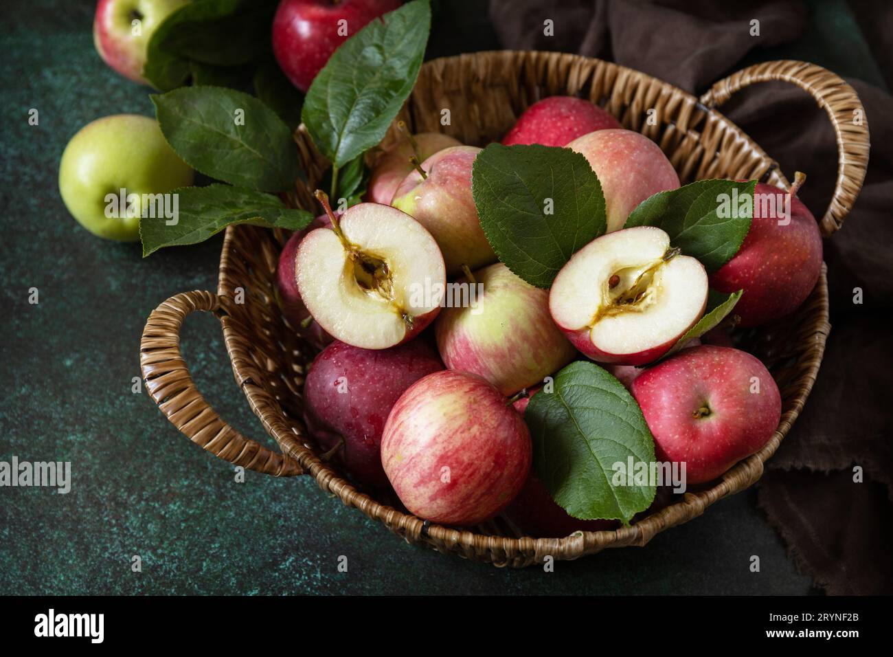 Frutta di fondo, frutta biologica. Cibo ancora vita. Cesto di mele mature su un tavolo di pietra. Foto Stock