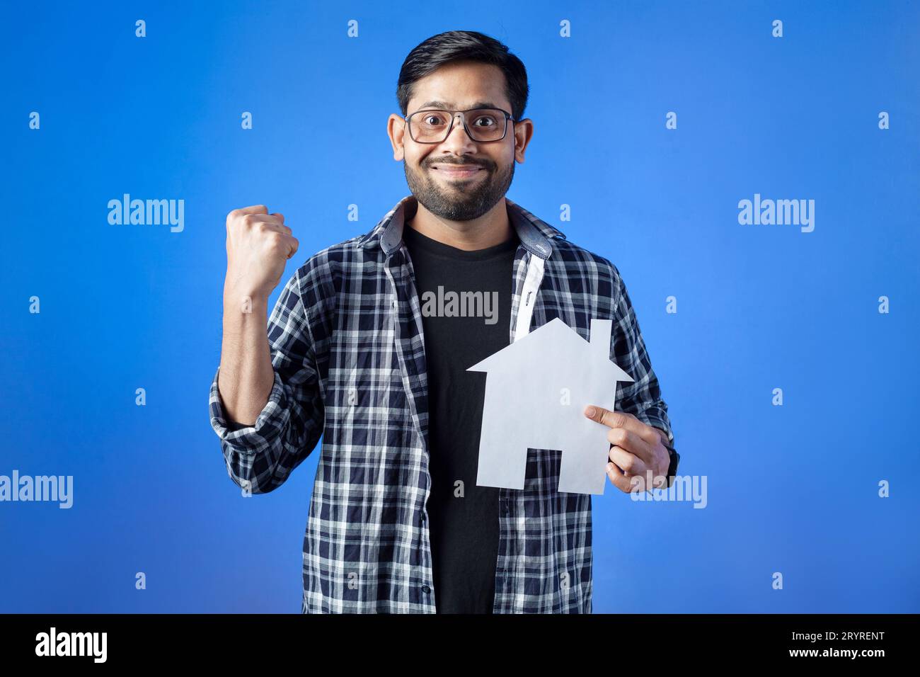 Immobili, mutui, assicurazione. Un uomo allegro che tiene un modello di casa. Foto Stock