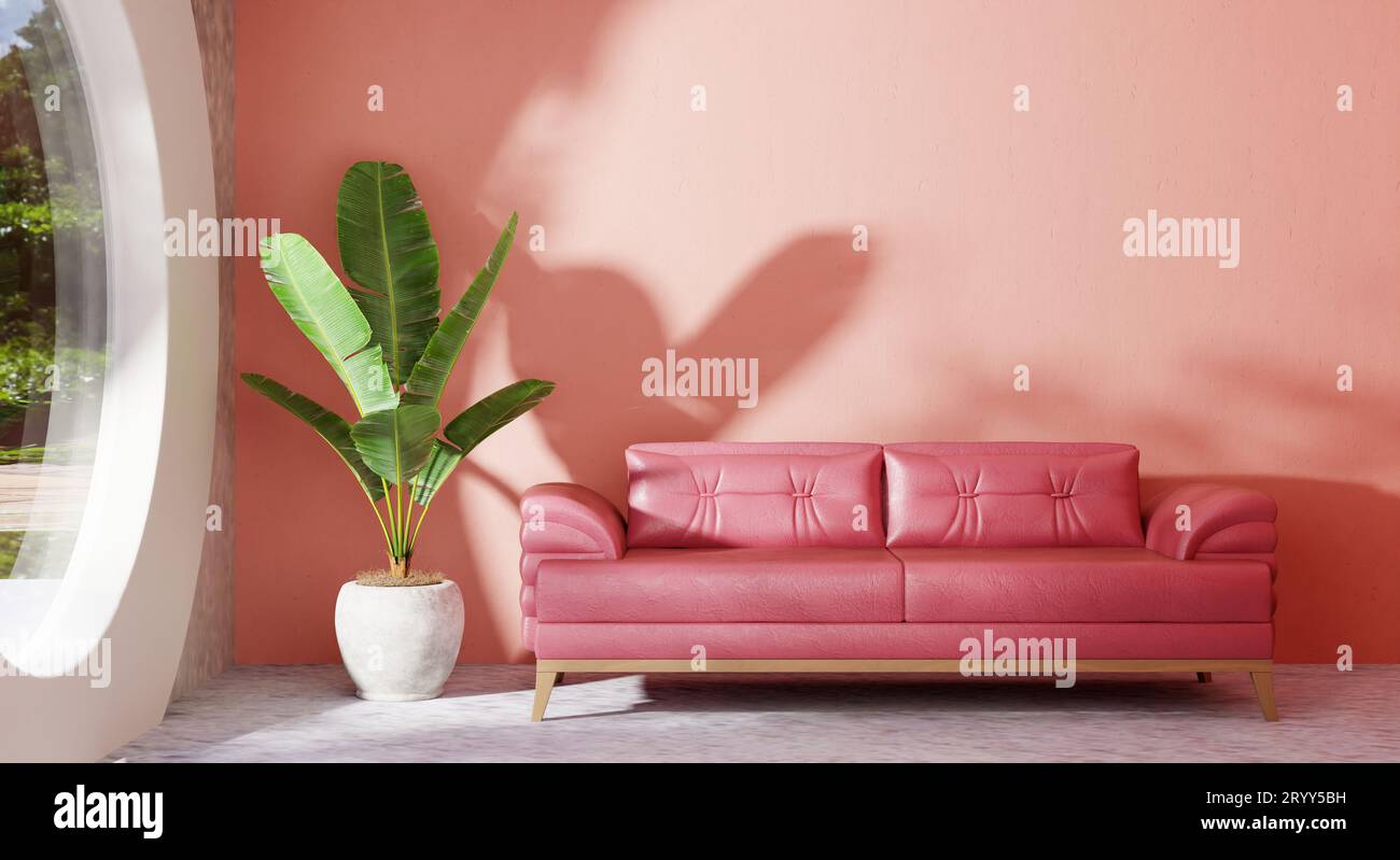 Accogliente divano color rosa pastello in un moderno soggiorno con piante di banana e vista sul giardino con finestra di vetro esterno su controsoffitto Foto Stock