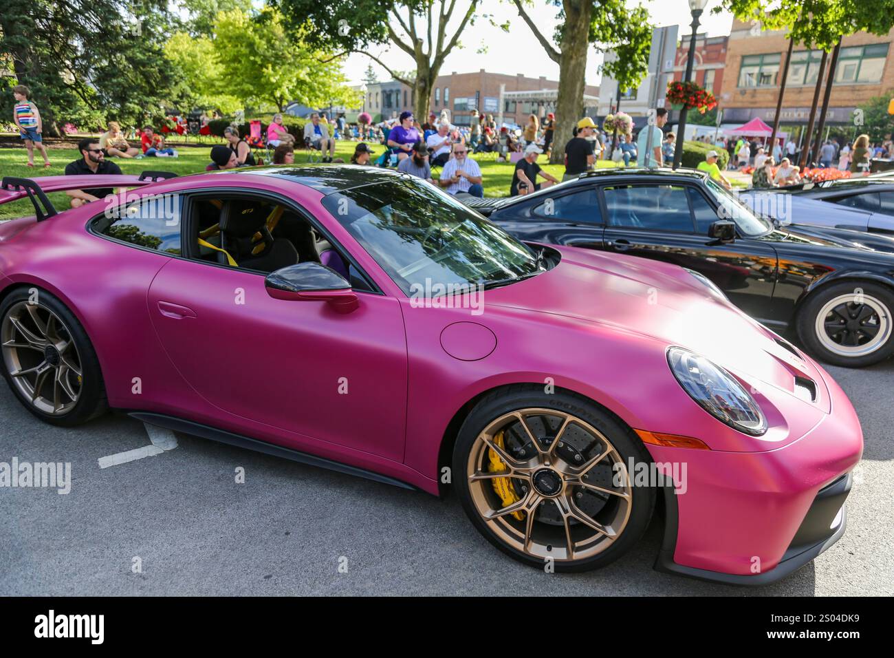 Un'auto sportiva Porsche 911 Carrera rosa fucsia opaca in mostra al Fast and Fabulous Car Show nel centro di Auburn, Indiana, USA. Foto Stock