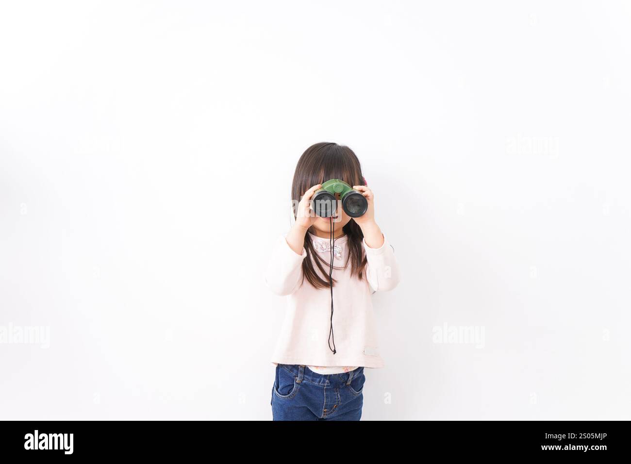 Bambino che usa un binocolo Foto Stock