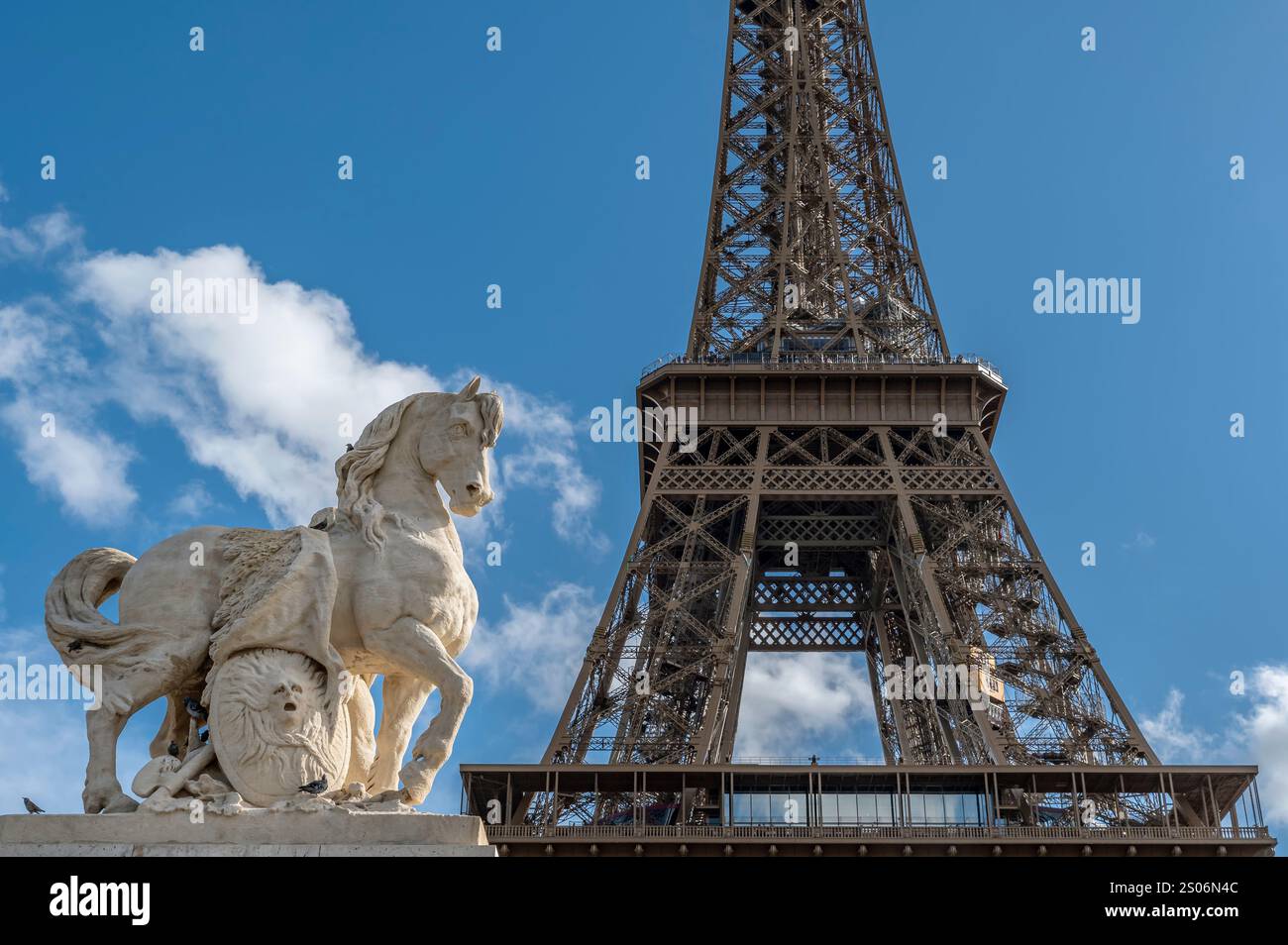 Statua del cavallo con accanto la parte centrale della Torre Eiffel, Parigi, Francia Foto Stock