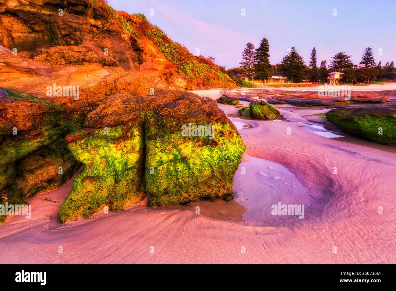 I salvatori di vita osservano la torre sulla spiaggia delle grotte della costa australiana del Pacifico all'alba. Foto Stock