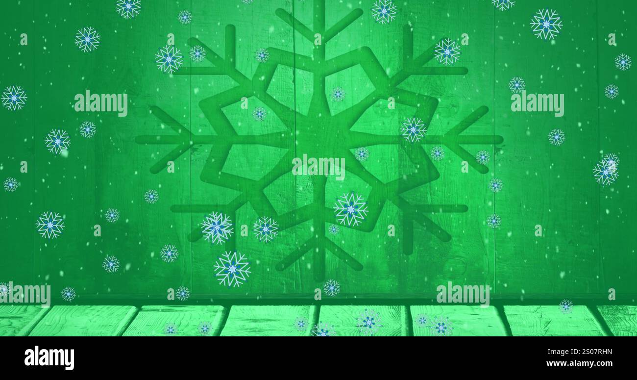 Immagine di fiocchi di neve che cadono sulla tavola di legno contro l'icona del fiocco di neve su sfondo verde Foto Stock