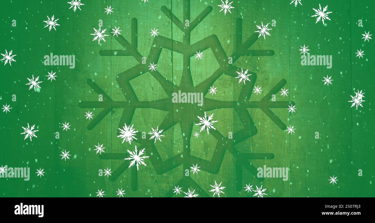 Immagine di fiocchi di neve che cadono sull'icona del fiocco di neve sfondo verde di legno Foto Stock