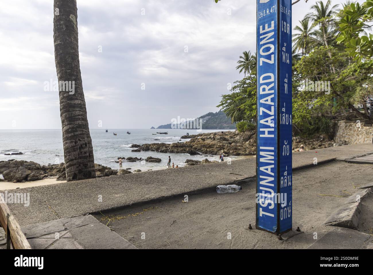 Zona di pericolo per lo tsunami. Cartello segnaletico, indicazione delle vie di fuga in caso di un altro terremoto. Area della spiaggia e strada costiera nella città di Patong, K. Foto Stock