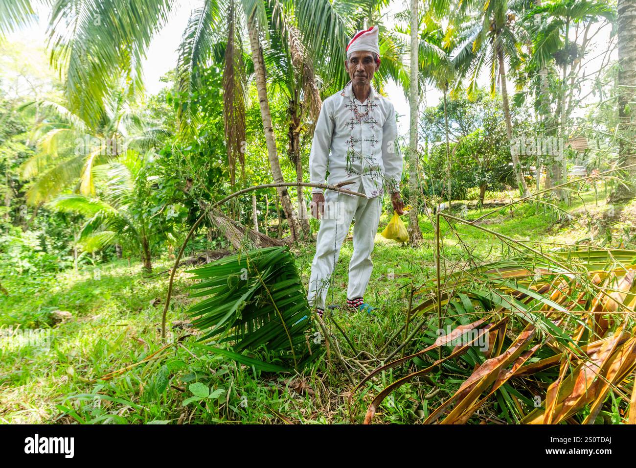 Un anziano Arumanen Manuvu tribale in abiti tradizionali che mostra una trappola per animali tribali utilizzata nella caccia a Cotabato nelle Filippine Foto Stock