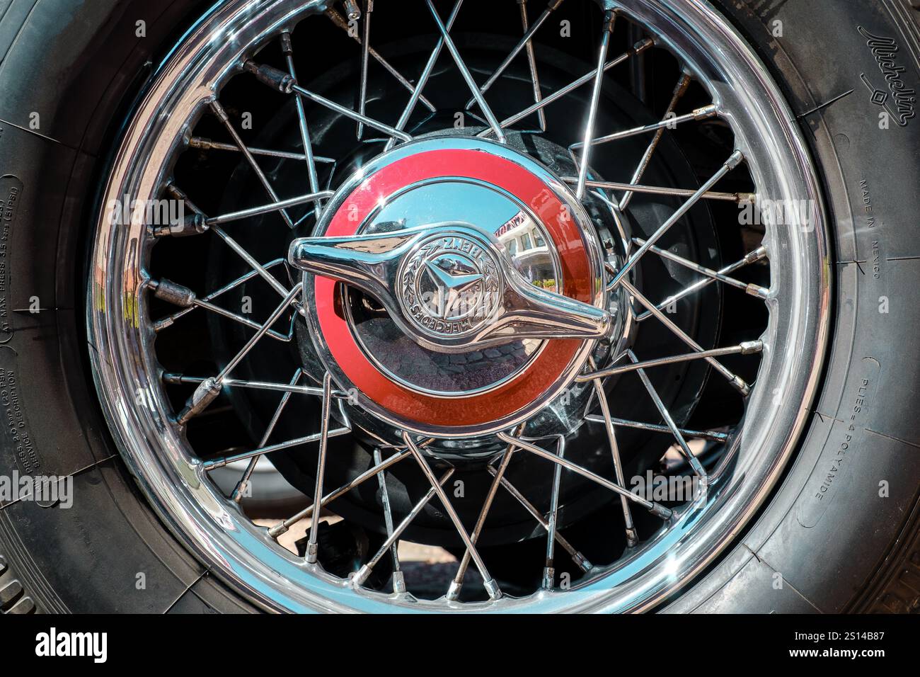Lisbona, Portogallo - 29 settembre 2024: Vista ravvicinata della ruota Mercedes-Benz d'epoca nelle giornate di sole. Ruota metallica con dettagli cromati e bordature solari, ruota con 2 orecchie con iconico marchio a stella a tre punte e logo Mercedes-Benz, pneumatici Michelin. Foto Stock