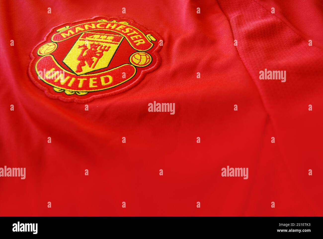 Foto ravvicinata angolata del distintivo del club del Manchester United sulla maglia con profondità di campo sfocata. Può essere utilizzato come modello grafico Foto Stock