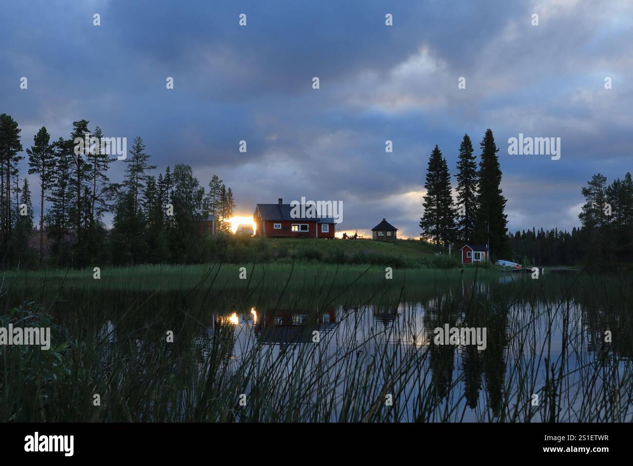 Splendide foto paesaggistiche al lago, alla natura e alla piccola casa rossa. Campagna svedese al tramonto. Sera. Jämtland, Svezia. Foto Stock