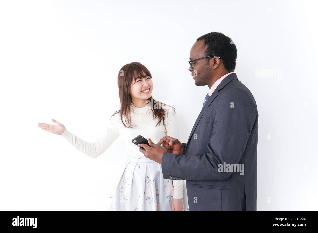 Giovane donna che dà indicazioni a uno straniero Foto Stock