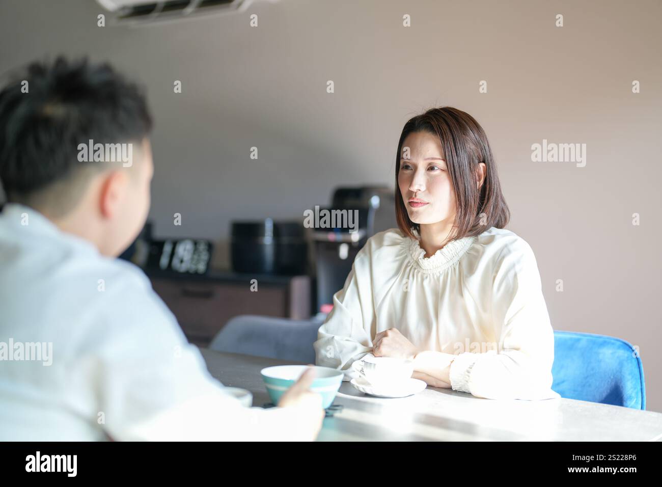 Una coppia giapponese, una donna di 30 anni e un uomo di 20 anni, si godono il tè pomeridiano a casa. Foto Stock