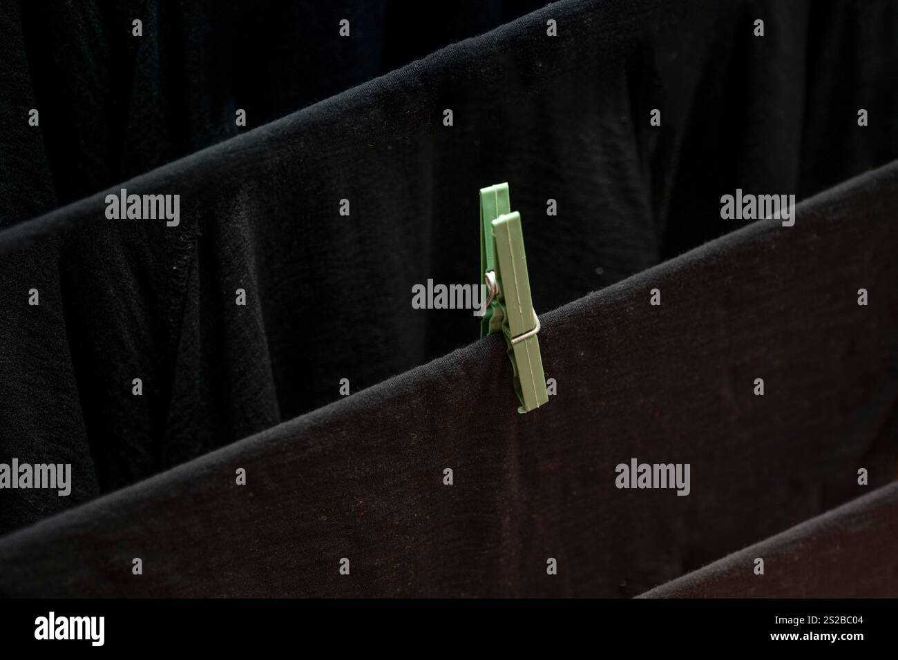 Lavanderia appesa a clothespins su una linea di abbigliamento all'interno della casa Foto Stock
