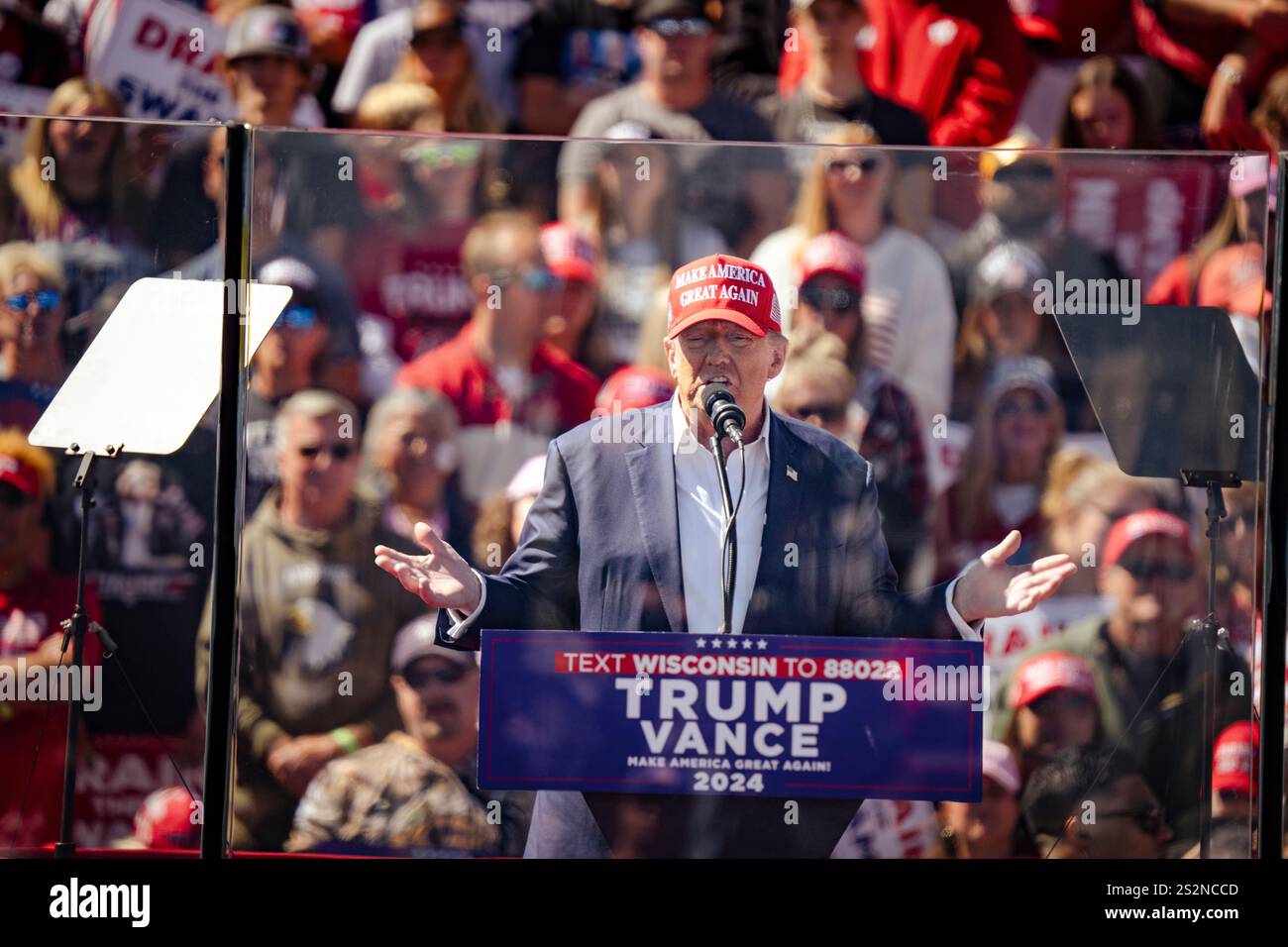 Donald Trump tiene un discorso dietro un vetro a prova di proiettile in un raduno all'aperto durante la campagna presidenziale del 2024. Foto Stock