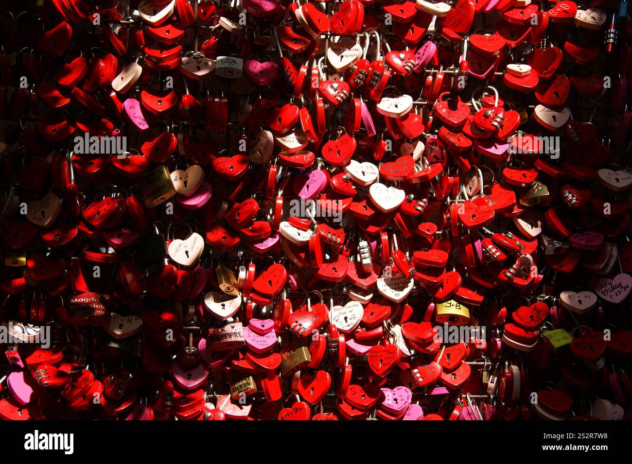 Innumerevoli lucchetti d'amore di diversi colori: Rosso, rosa, bianco, dorato come simboli dell'amore eterno Foto Stock