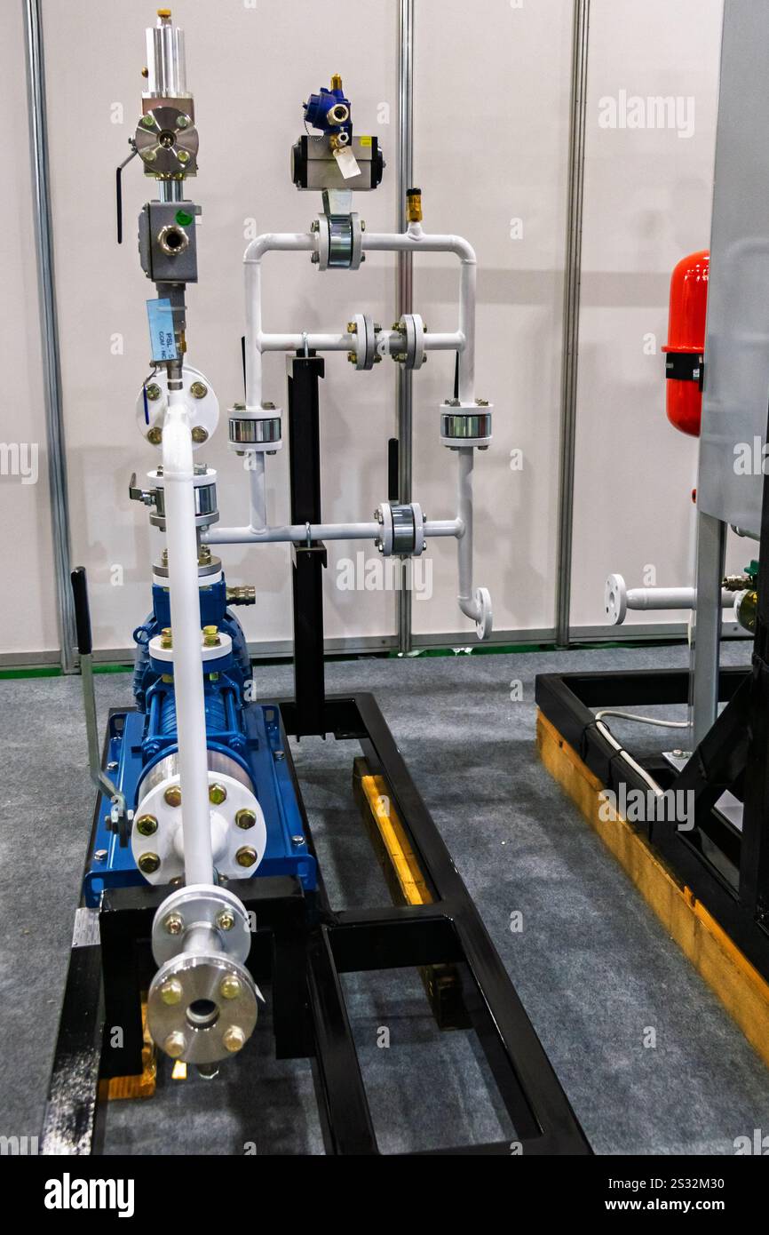 Pompa a membrana industriale con sistema di tubazioni. Impianto idraulico con manometro e distributore idraulico. Foto Stock