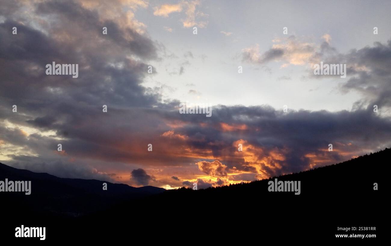 Nuvole rosse e blu al tramonto sulle montagne. Foto natura. Nuvole rosse e blu al tramonto sulle montagne Foto Stock