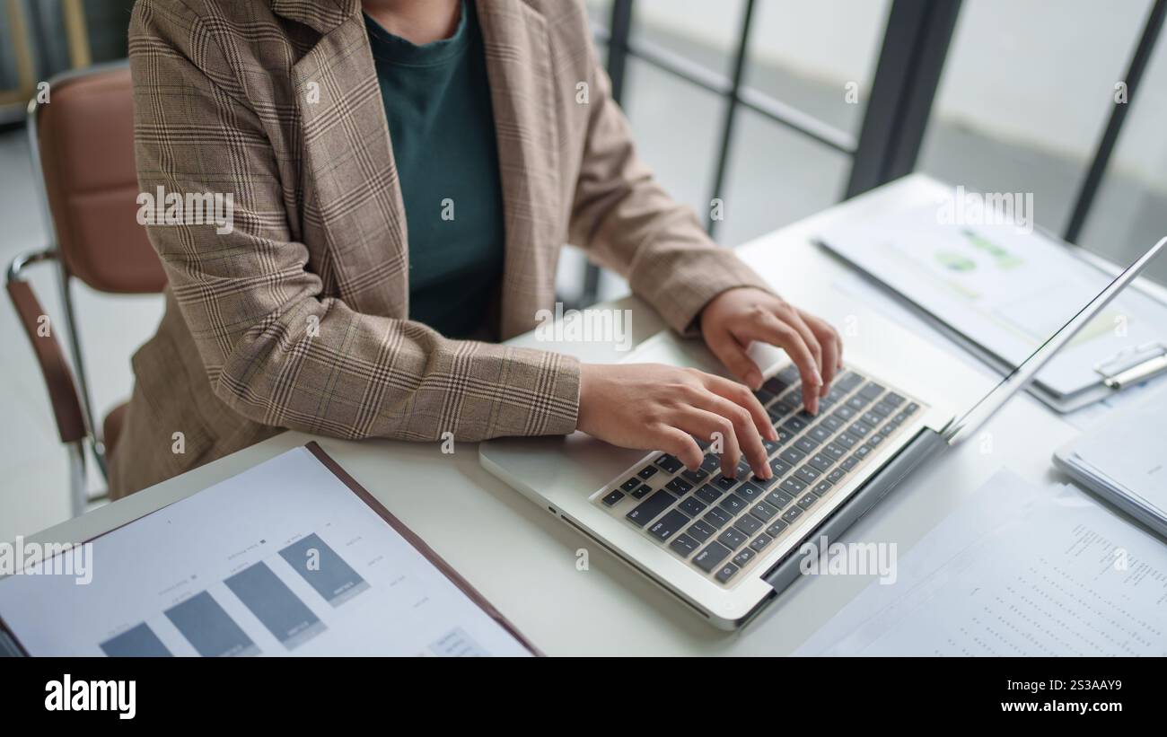 Donna d'affari che lavora con le mani di un notebook che digita la tastiera. Investitore professionista che lavora per un nuovo progetto di Start-up. pianificazione aziendale in ufficio. Tecnologia Foto Stock
