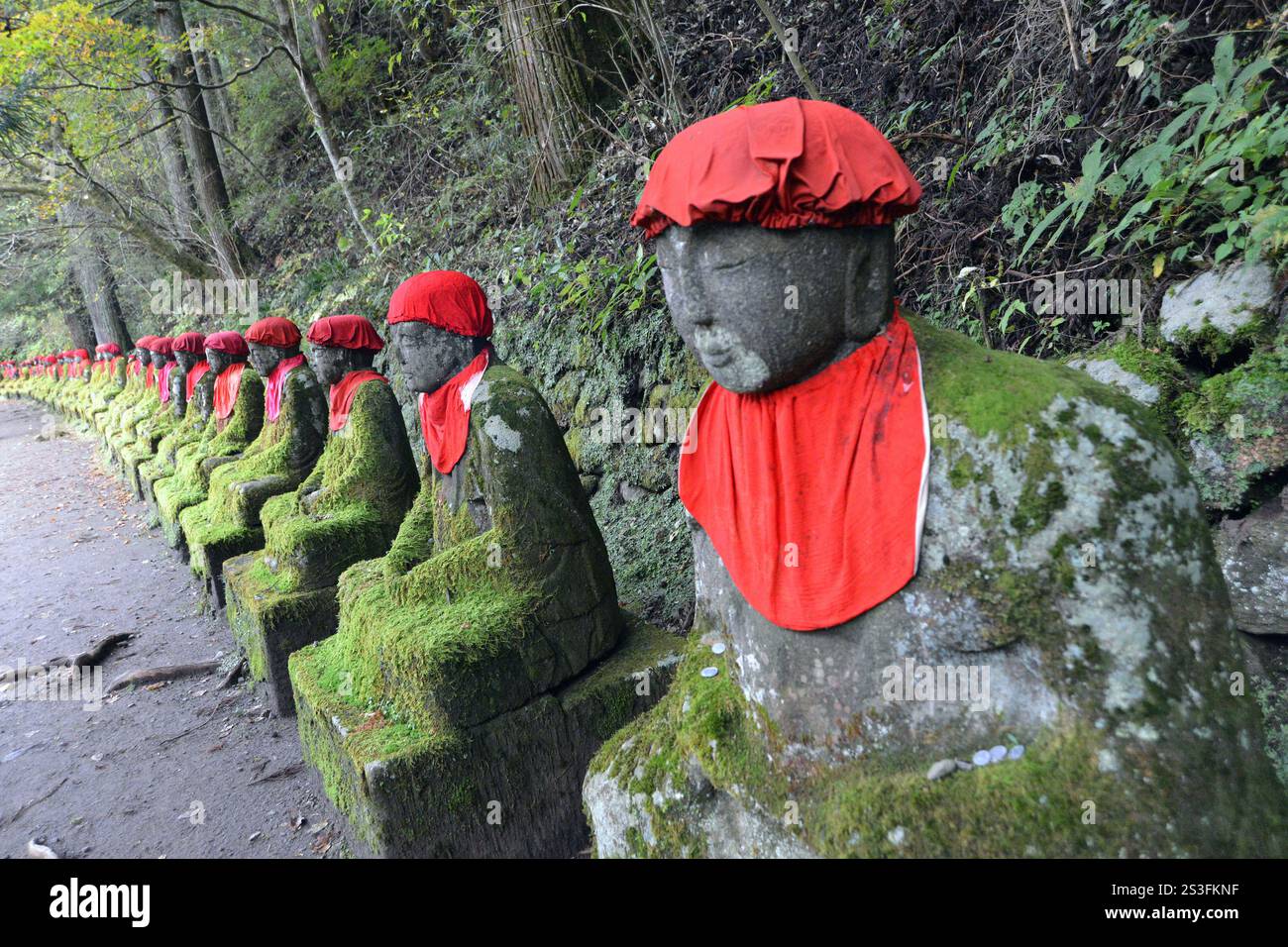 Le statue buddiste indossano bavaglino rosso nel Parco Nazionale di Nikko, in Giappone, per proteggere i viaggiatori e sono custodi dei bambini in questa area del Patrimonio Nazionale Foto Stock