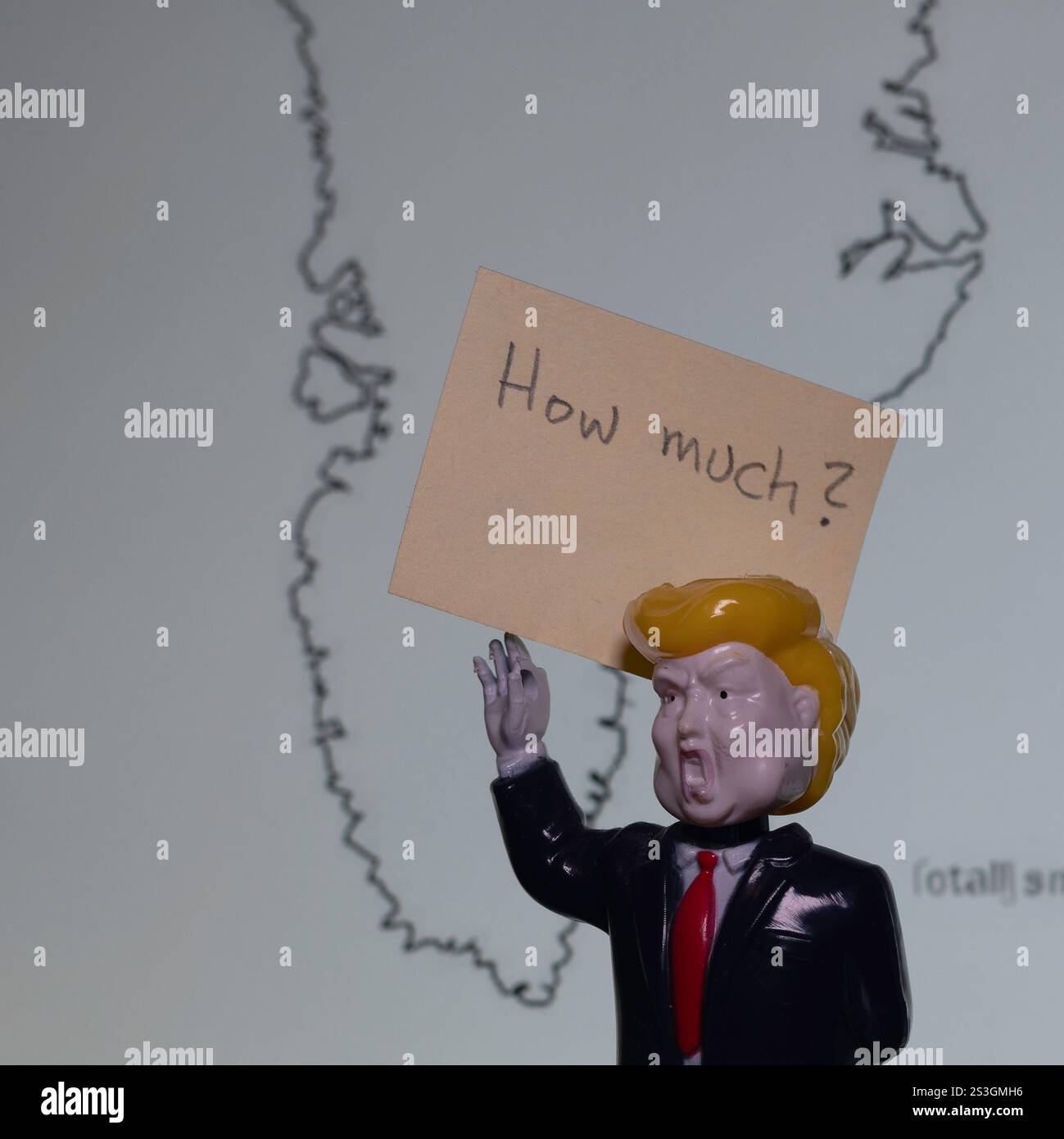 Giocattolo di plastica di Donald Trump con un cartello davanti alla mappa della Groenlandia, Danimarca, 9 gennaio 2025 Foto Stock