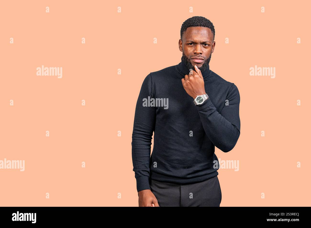 Ritratto in studio di un giovane uomo d'affari afroamericano che pensa con la mano sul mento Foto Stock