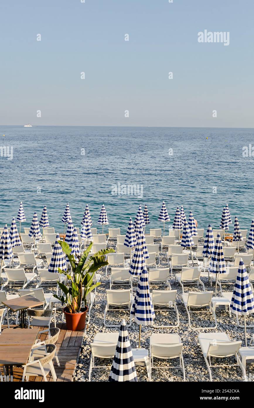 Spiaggia panoramica con ombrelloni a righe sulla Costa Azzurra Foto Stock