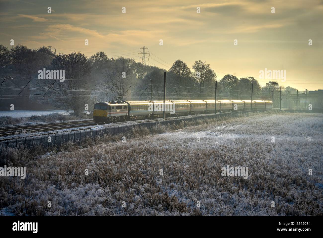 Locomotiva elettrica Royal Sovereign 87002 che trasporta la ferrovia Capitals Scot da Londra a Edimburgo attraverso i campi ghiacciati di Winwick, a ovest Foto Stock