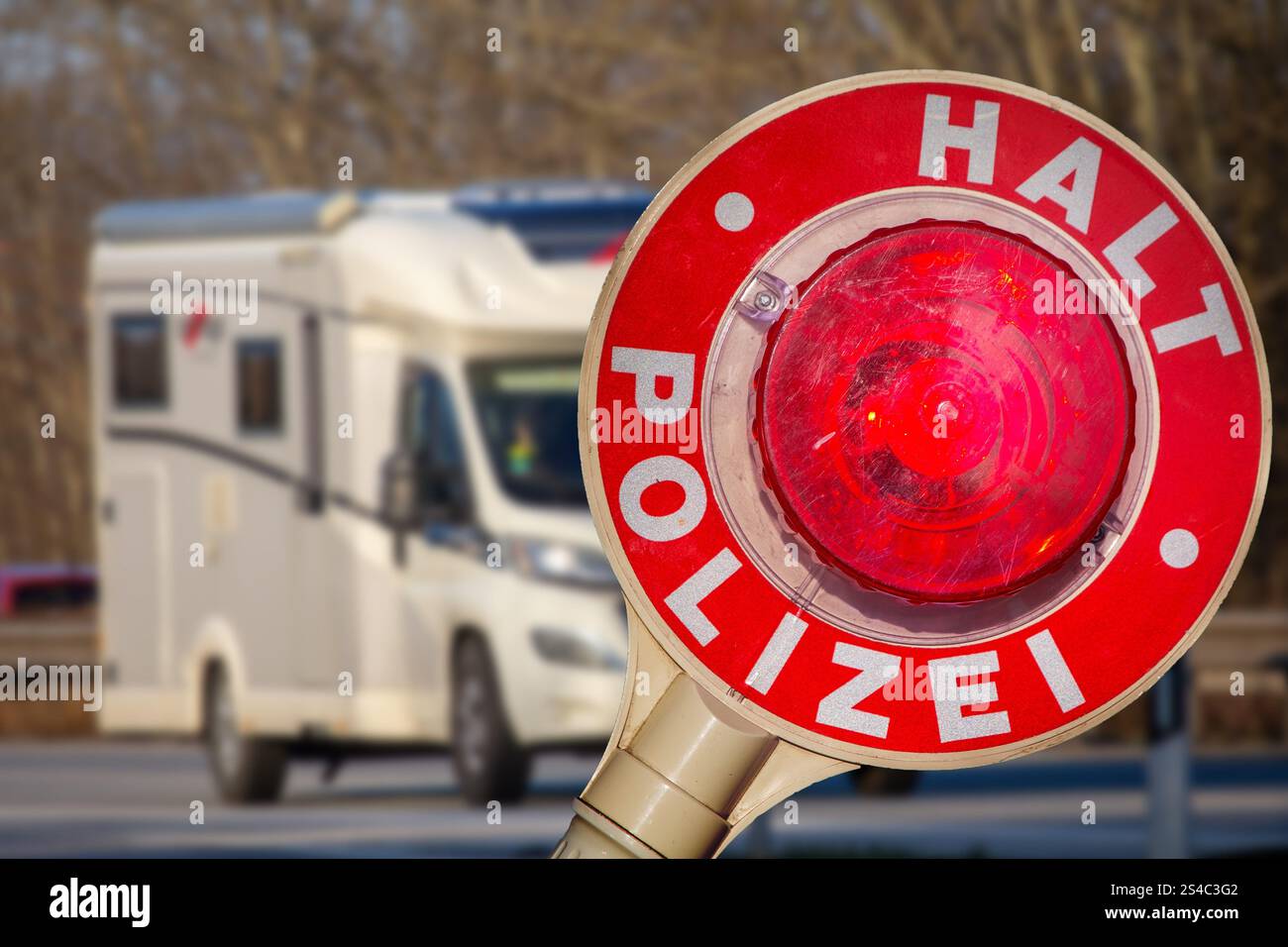 Controllo di polizia (Germania): Primo piano di una cazzuola di polizia con l'iscrizione HALT POLIZEI (polizia di arresto) di fronte a un camper (composizione) Foto Stock Controllo di polizia (Germania): Primo piano di una cazzuola di polizia con l'iscrizione HALT POLIZEI (polizia di arresto) di fronte a un camper (composizione) Foto Stock
