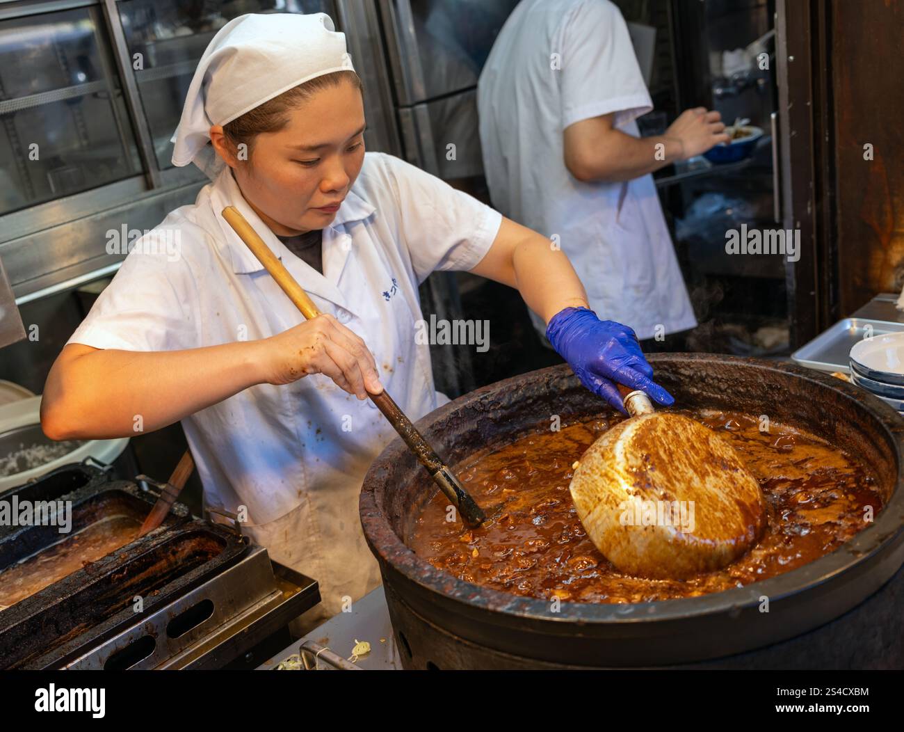 Chef donna che cucina al ristorante Gyu-Don Beef Stew al ristorante Kitsuneya Tsukiji Outer Market Tokyo Giappone Foto Stock