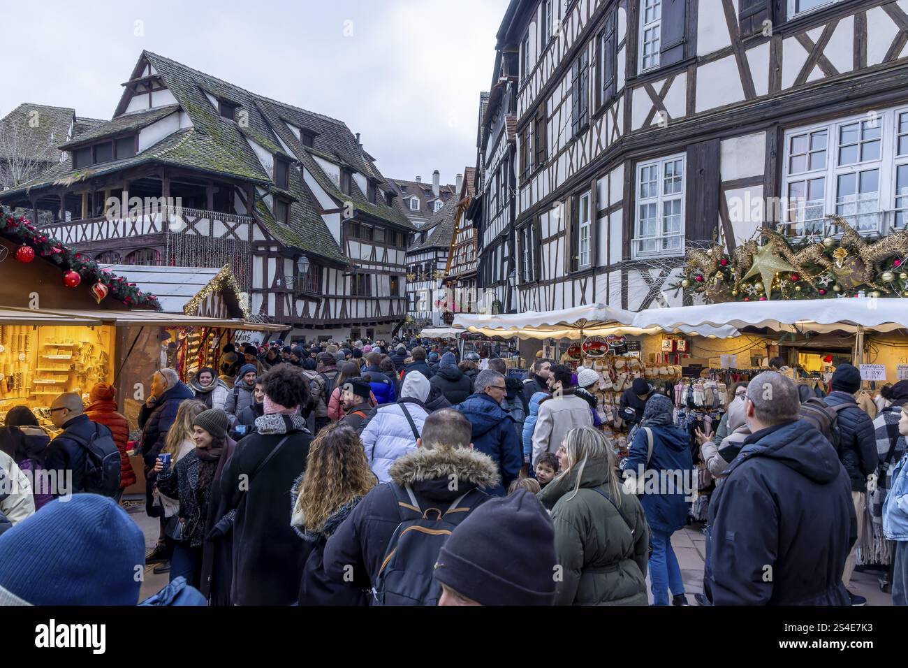 I turisti passeggiano attraverso il mercatino di Natale circondato da case a graticcio nella città vecchia, la Petite France, Strasburgo, Alsazia, dipartimento Ba Foto Stock