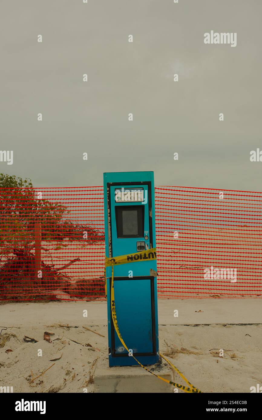 Solo per uso editoriale 12 gennaio 2025 St. Pete Beach, Florida, Stati Uniti. Parchimetro blu danneggiato con nastro di avvertenza giallo e recinzione rossa. Niente persone. Foto Stock