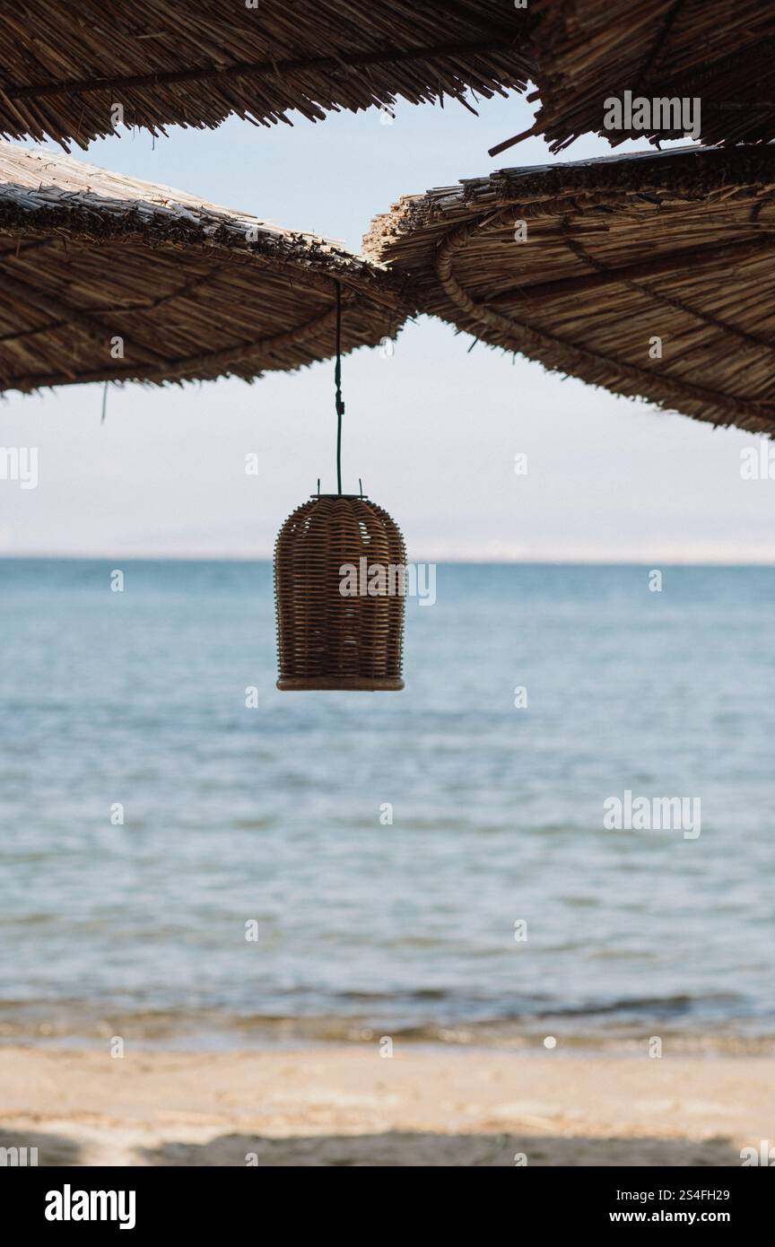 ombra sulla spiaggia con ombrelloni di paglia tazze e decorazioni rustiche Foto Stock
