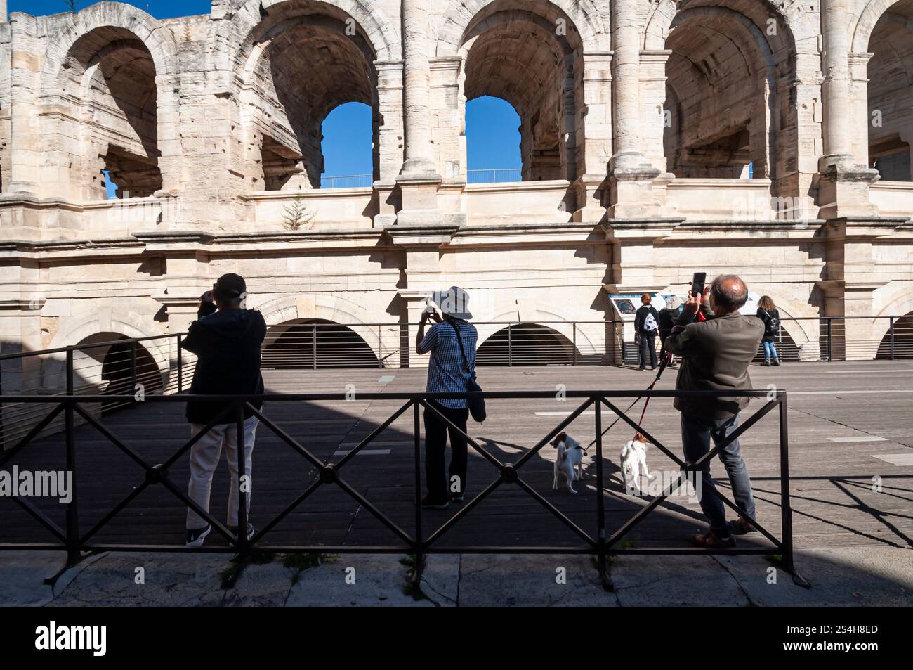 Arles, turisti giapponesi che scattano foto all'anfiteatro romano, alle Bouches du Rhône, alla Provence-Alpes-Côte d'Azur, Francia. Foto Stock