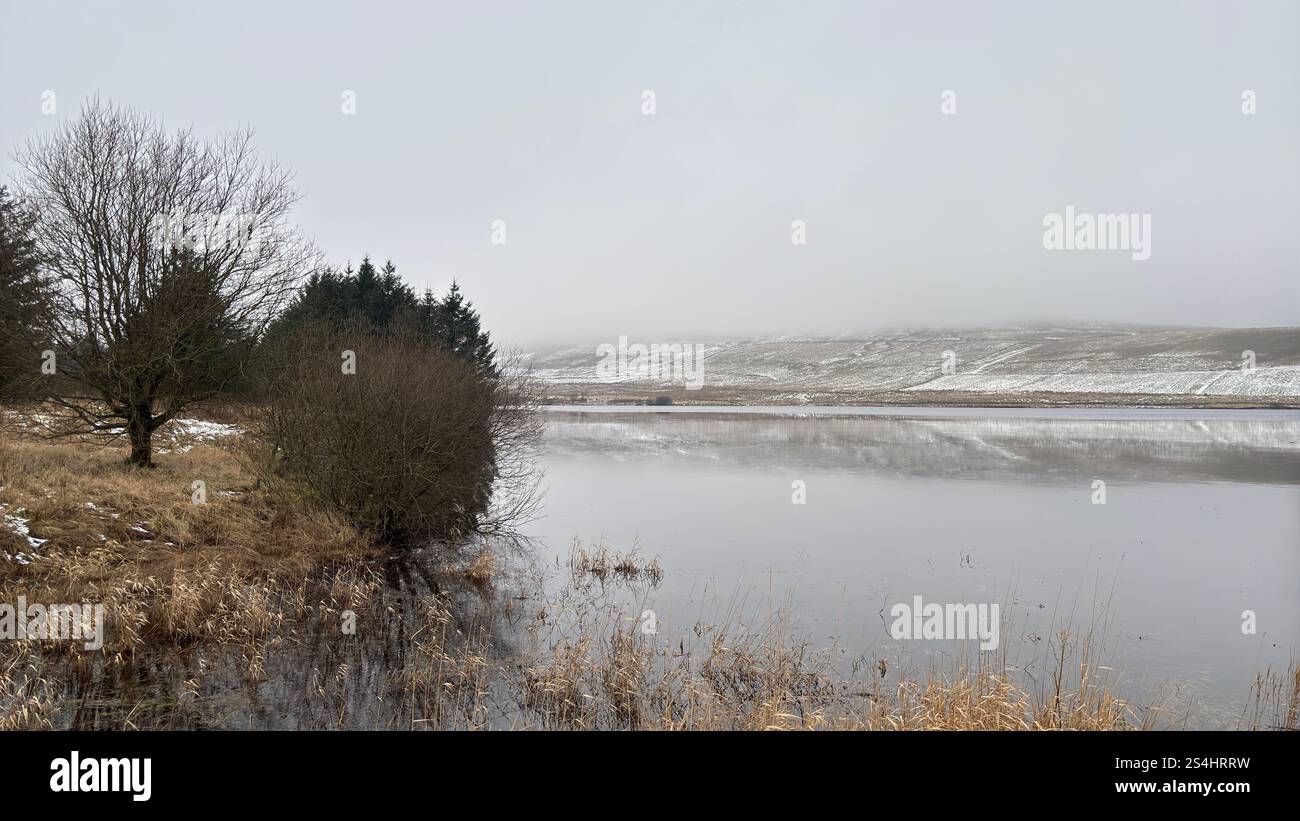 Harperleas Reservoir a Glen vale, Scozia. In inverno con superficie d'acqua ghiacciata. - Immagine stock catturata con smartphone