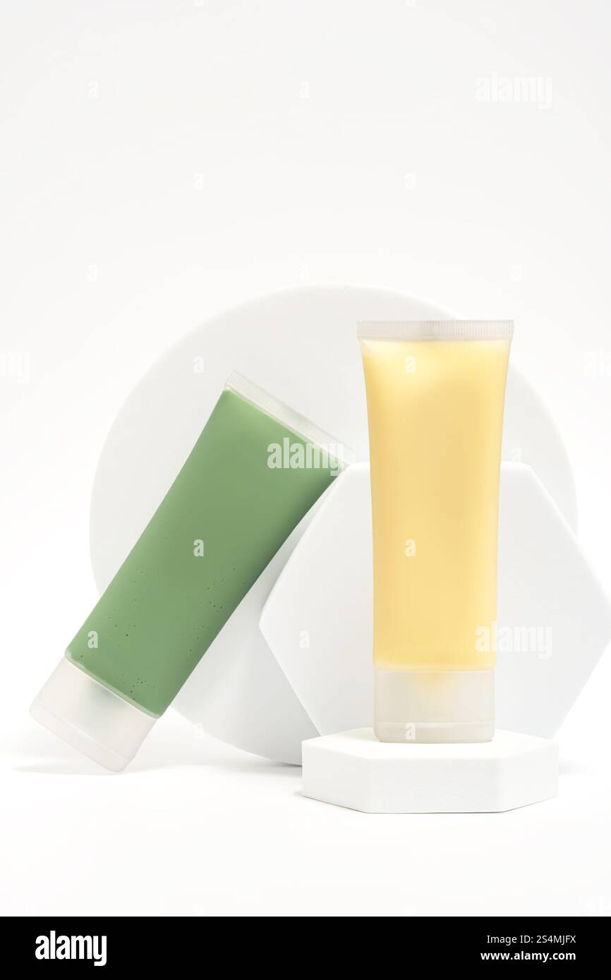 Mostra una spirulina verde, un caolino e una maschera di tè verde accanto a una maschera gialla al miele di manuka, presentata su moderni piedistalli bianchi contro un bianco immacolato Foto Stock
