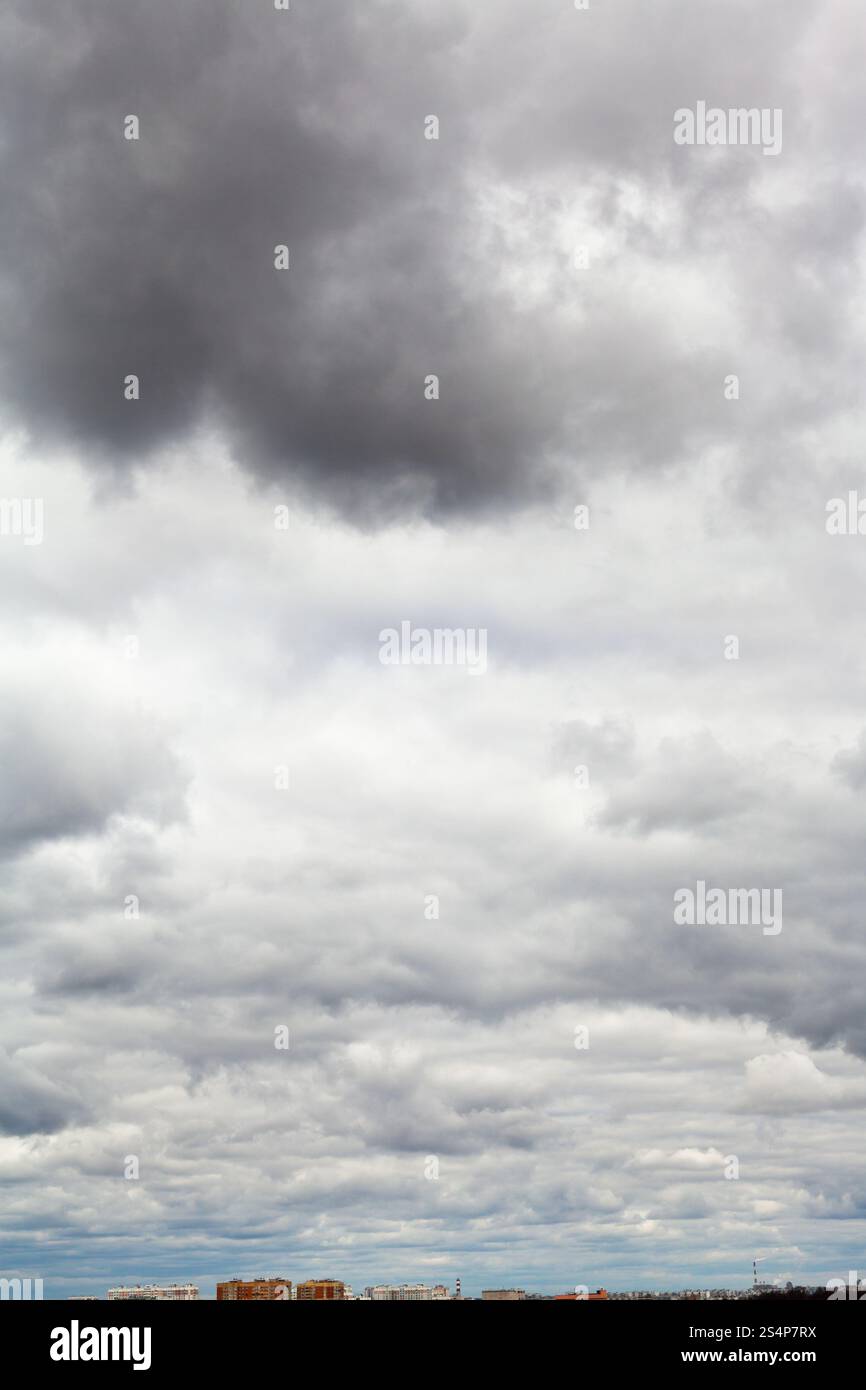 Grandi scure nuvole di pioggia sotto la città in primavera Foto Stock